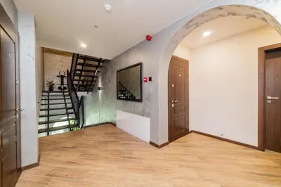 an arched hallway with a staircase in a house at Svečių namai Imperija in Šiauliai