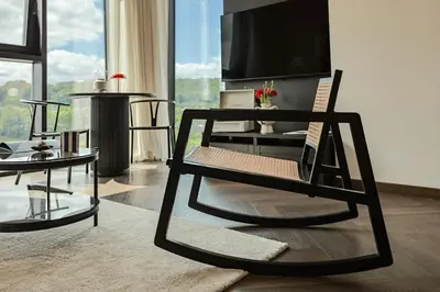 a living room with a chair and a tv at River home in Kaunas