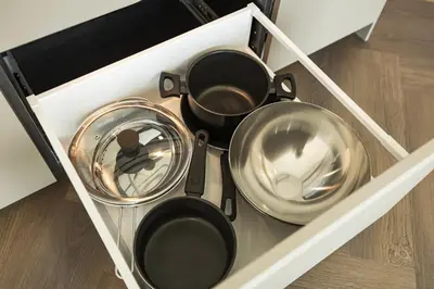 a drawer with several pots and pans in it at River home in Kaunas