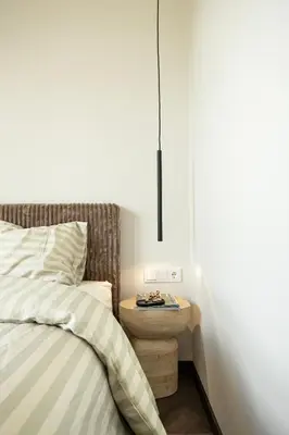a bedroom with a bed with a night stand next to it at River home in Kaunas