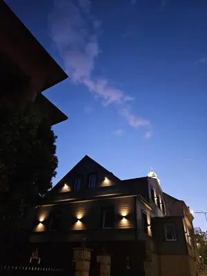a house lit up at night with lights on it at VV apartamentai in Kaunas