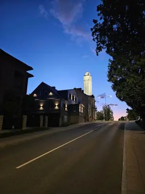 an empty street with a building and a water tower at VV apartamentai in Kaunas