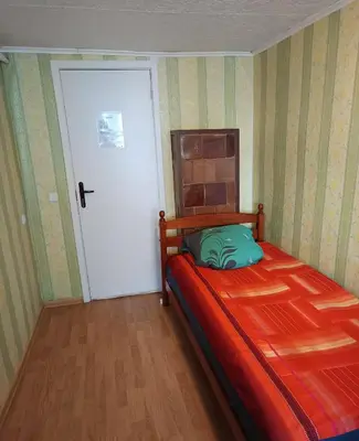 a bedroom with a bed and a white door at Cosy Charming Guest House in central of Marijampole in Marijampolė