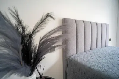 a bedroom with a bed and a plant at MARVEL apartamentai in Kaunas