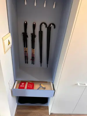 a row of black umbrellas in a closet at Aqua Lagoon Druskininkai in Druskininkai