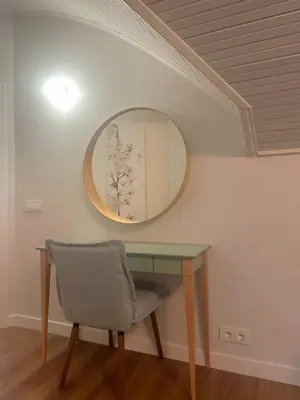a dressing table with a mirror and a chair at Aqua Lagoon Druskininkai in Druskininkai
