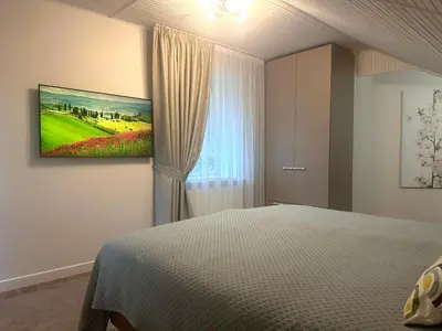 a bedroom with a bed and a painting on the wall at Aqua Lagoon Druskininkai in Druskininkai