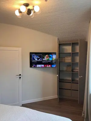 a bedroom with a flat screen tv on the wall at Aqua Lagoon Druskininkai in Druskininkai