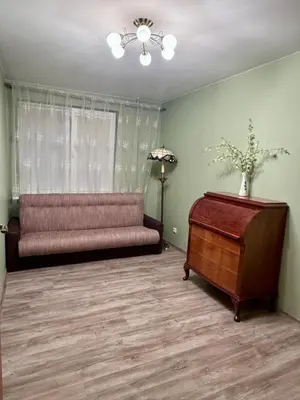 a living room with a couch and a table at Central Modern Two Bedroom Apartment in Druskininkai