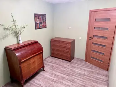 a room with a dresser and a wooden door at Central Modern Two Bedroom Apartment in Druskininkai