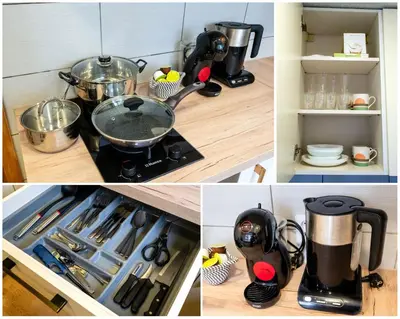 a kitchen with a stove with pots and pans at Cozy Coner Apartments in Kaunas