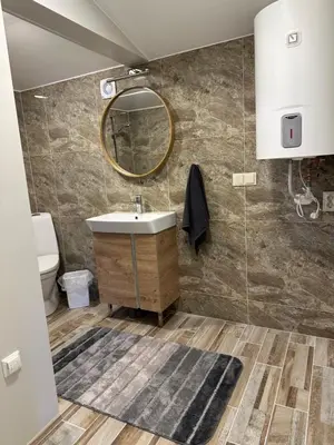 a bathroom with a sink and a mirror at Apartamentai LUKA in Marijampolė