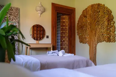 a room with two beds and a door to a wine cellar at Shanti Resort & Deluxe SPA in Sarboriškės I