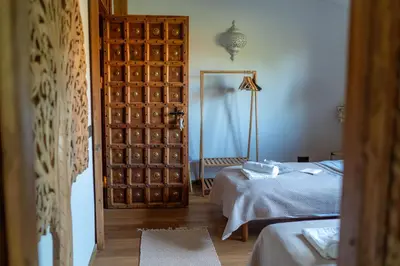 a bedroom with a door and a bed and a mirror at Shanti Resort & Deluxe SPA in Sarboriškės I
