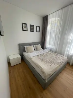 a bedroom with a large bed and a window at River House City center in Kaunas