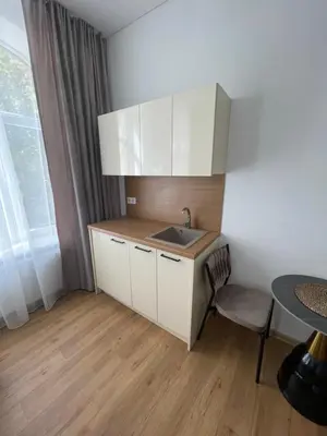 a kitchen with a sink and a table at River House City center in Kaunas
