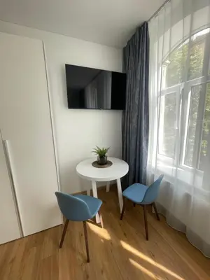 a room with a table and two chairs and a window at River House City center in Kaunas