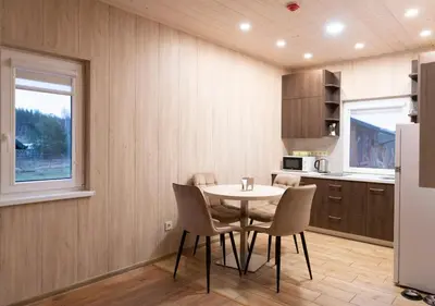 a kitchen with a table and chairs in a room at GobeHouse Sodyba in Vilkanastrai