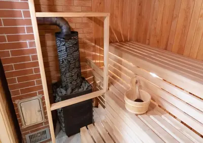 a inside of a sauna with a heater in it at GobeHouse Sodyba in Vilkanastrai