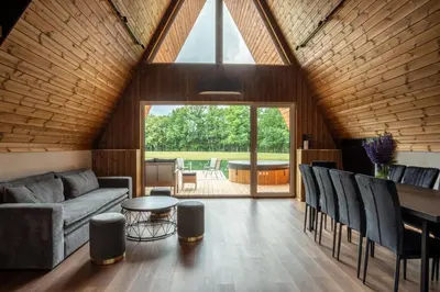 a living room with a couch and a table at Poilsio Vingis in Liūnai