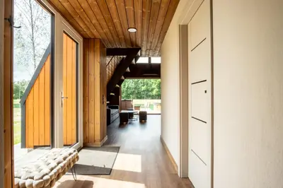 a hallway of a house with wooden ceilings at Poilsio Vingis in Liūnai