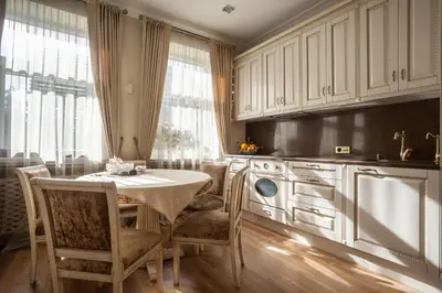 a kitchen with a table and chairs in a kitchen at Boutique Classic Apartment in Kaunas Center in Kaunas