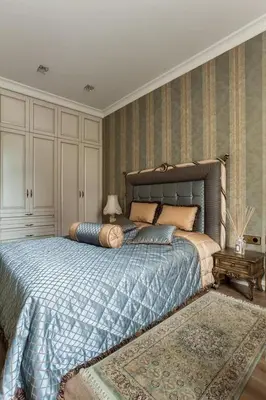a bedroom with a large bed with a blue blanket at Boutique Classic Apartment in Kaunas Center in Kaunas