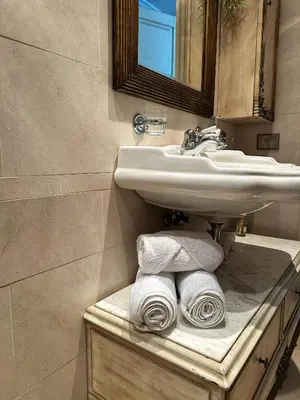 a bathroom with a sink and towels on a counter at Boutique Classic Apartment in Kaunas Center in Kaunas
