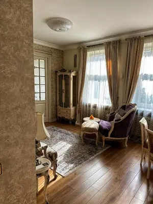 a living room with a chair and a table at Boutique Classic Apartment in Kaunas Center in Kaunas