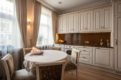 a kitchen with a table and chairs and a window at Boutique Classic Apartment in Kaunas Center in Kaunas