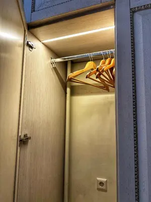 a closet with a bunch of orange hoses in it at Boutique Classic Apartment in Kaunas Center in Kaunas