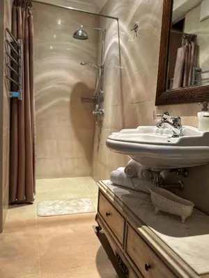 a bathroom with a sink and a shower at Boutique Classic Apartment in Kaunas Center in Kaunas