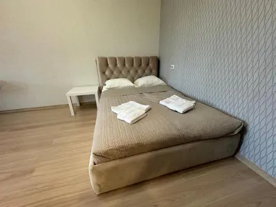 a bedroom with a bed with two towels on it at Baltijos Apartment in Kaunas