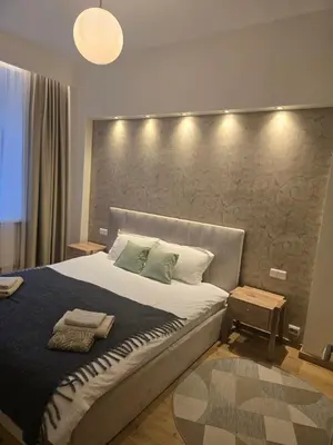 a bedroom with a large bed with a large headboard at Cozy & Silent Apartment in Vilnius