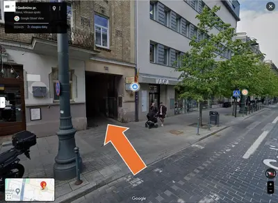 a street with an orange arrow pointing to a building at Cozy & Silent Apartment in Vilnius