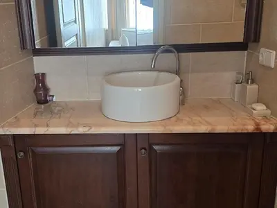 a bathroom counter with a sink and a mirror at Cozy & Silent Apartment in Vilnius