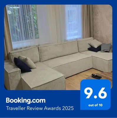 a large couch in a living room with at Cozy & Silent Apartment in Vilnius