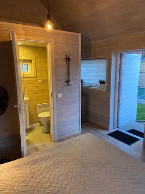 a room with a bathroom with a toilet and a window at Atostogu namelis in Anykščiai