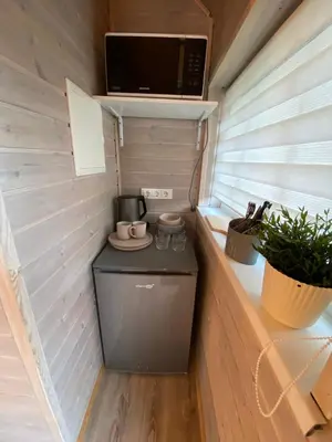 a small kitchen in a tiny house at Atostogu namelis in Anykščiai