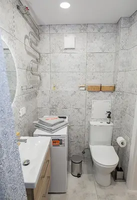 a bathroom with a white toilet and a sink at Šviesus ir jaukus butas Šiaulių centre puiki vieta poilsiui #2 in Šiauliai