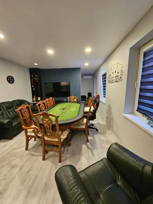 a living room with a green table and chairs at Kaunas Pramogų kambarys in Kaunas