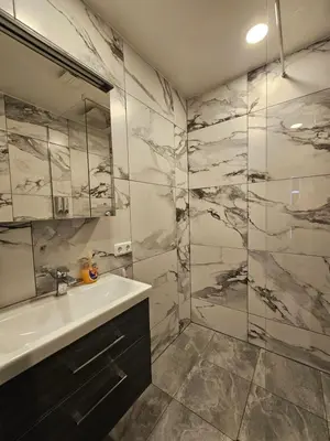 a bathroom with a sink and a shower at Kaunas Pramogų kambarys in Kaunas
