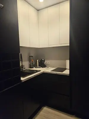 a kitchen with white cabinets and a sink at Kaunas Pramogų kambarys in Kaunas