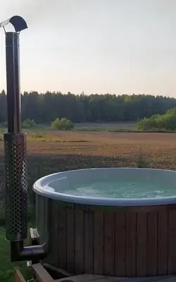 a hot tub in the middle of a field at Mango namelis in Žuvininkai