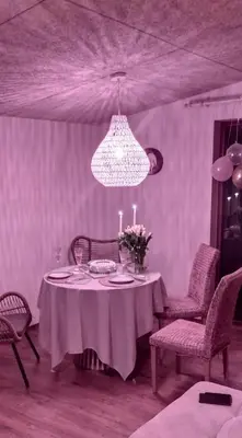 a dining room with a table and a chandelier at Mango namelis in Žuvininkai