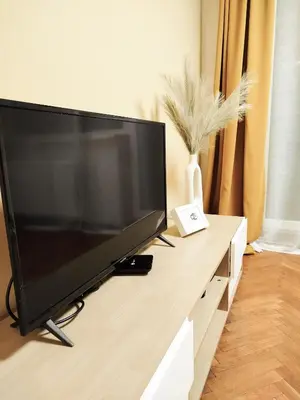a large flat screen tv sitting on top of a counter at Cozy Noko Apartments in Kaunas
