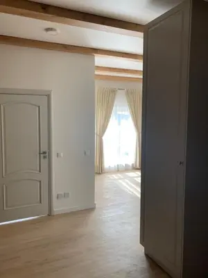 an empty room with a door and a window at Apartamentai Domus Antiqua in Zarasai