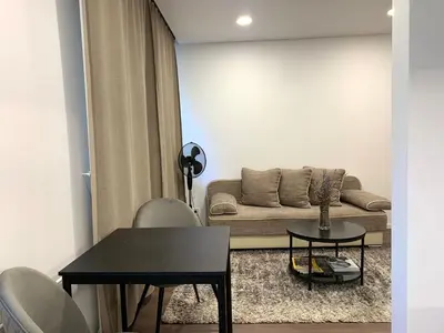 a living room with a couch and a table at Cozy Studio Apartment in the City Center in Šiauliai