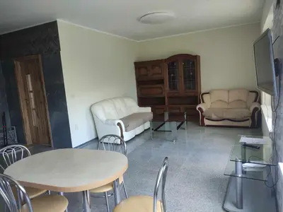 a living room with a table and chairs at Rent Olamit in Karkazai