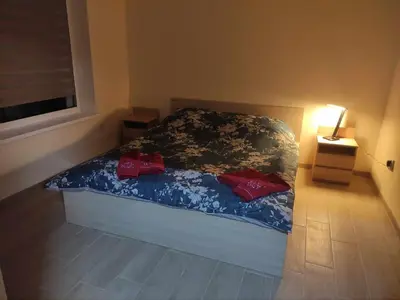 a bedroom with a bed with two red pillows at Rent Olamit in Karkazai